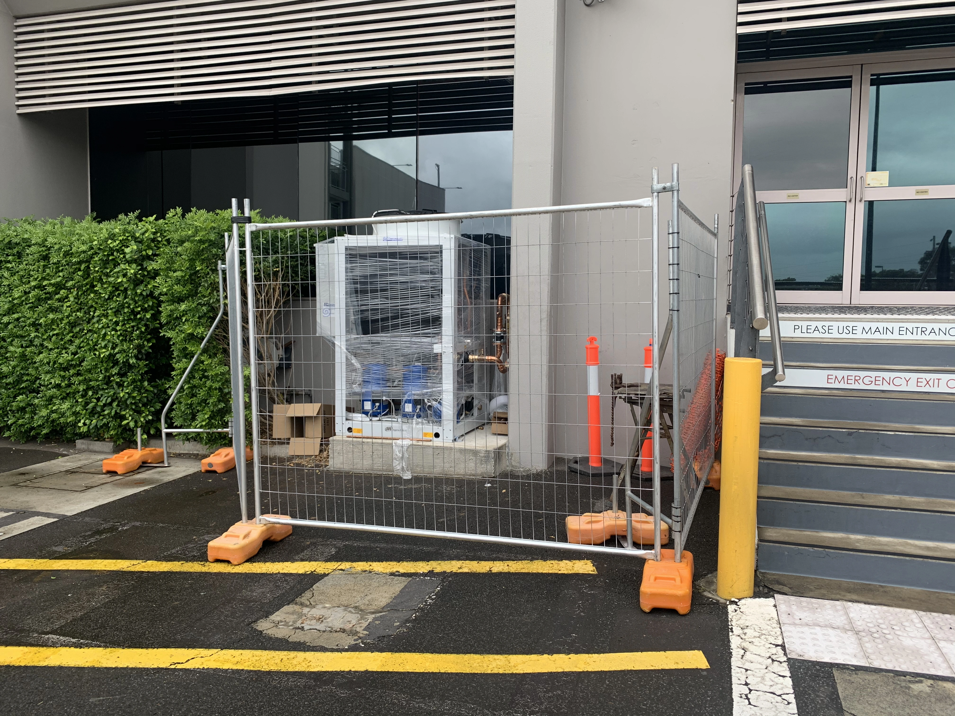 Commercial air conditioning installation with protected site access.