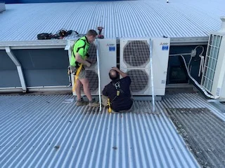 Ultimate 1 technicians working on rooftop equipment